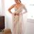 Cream tissue satin sequins saree with unstitched blouse piece.