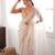 Cream tissue satin sequins saree with unstitched blouse piece.