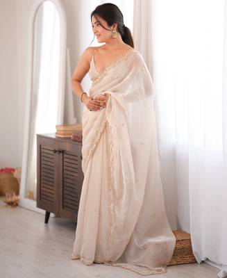 Cream tissue satin sequins saree with unstitched blouse piece. 5