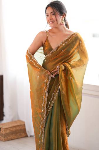 Gold tissue satin sequins saree with unstitched blouse piece.