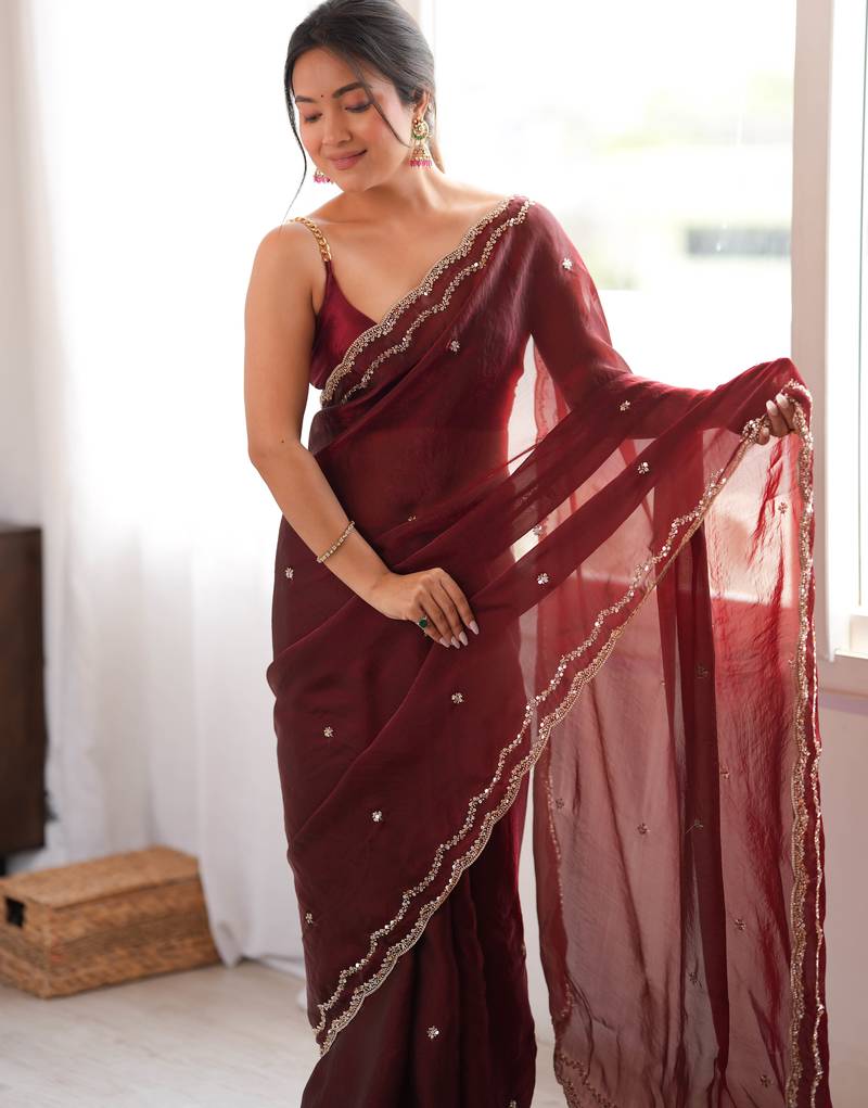 Maroon tissue satin sequins saree with unstitched blouse piece.