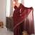 Maroon tissue satin sequins saree with unstitched blouse piece.