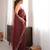 Maroon tissue satin sequins saree with unstitched blouse piece.