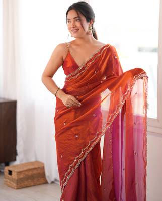 Orange tissue satin sequins saree with unstitched blouse piece. 1