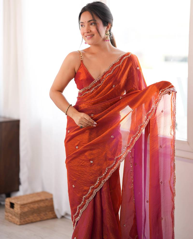 Orange tissue satin sequins saree with unstitched blouse piece.