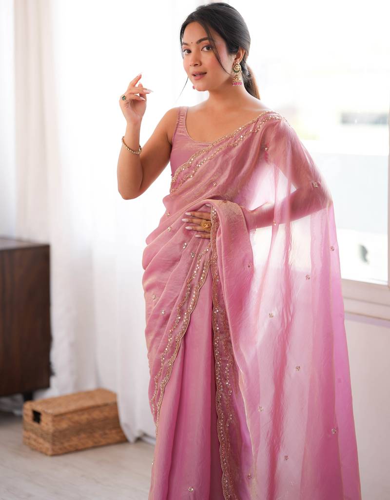 Pink tissue satin sequins saree with unstitched blouse piece.