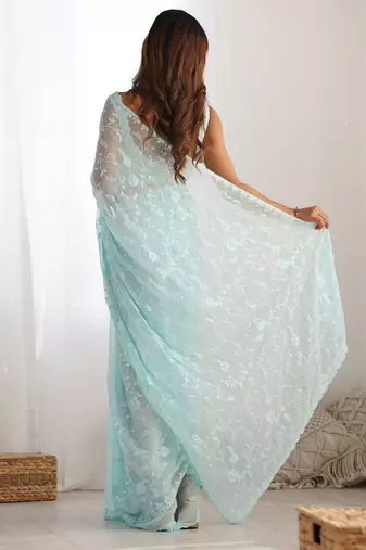 Sky blue tissue satin sequins saree with unstitched blouse piece.