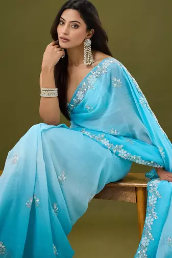 Blue tissue satin embellished saree with unstitched blouse piece.