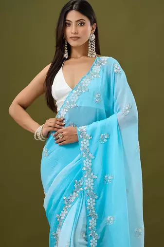 Blue tissue satin embellished saree with unstitched blouse piece.