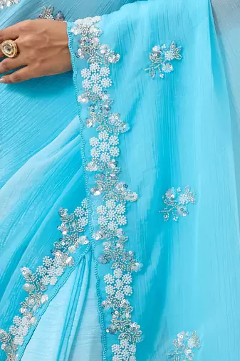 Blue tissue satin embellished saree with unstitched blouse piece.