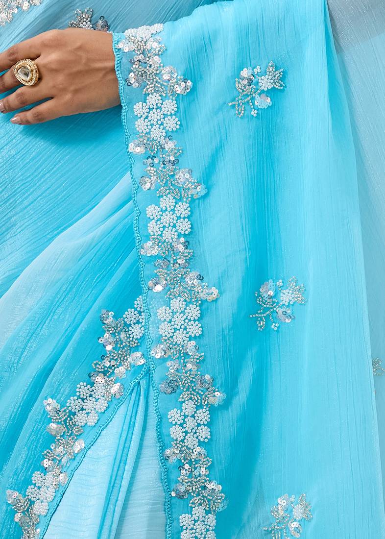 Blue tissue satin embellished saree with unstitched blouse piece.