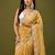 Mustard tissue satin embellished saree with unstitched blouse piece.