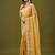 Mustard tissue satin embellished saree with unstitched blouse piece.