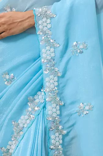 Sky blue tissue satin embellished saree with unstitched blouse piece.