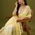 Yellow tissue satin embellished saree with unstitched blouse piece.
