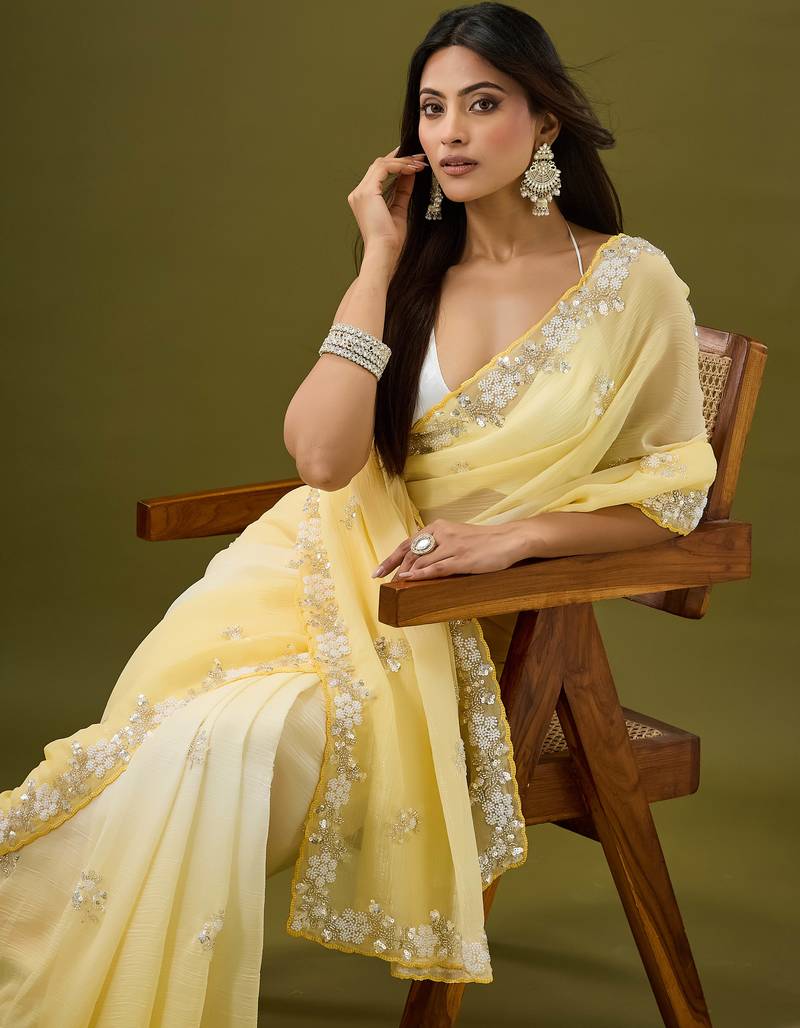 Yellow tissue satin embellished saree with unstitched blouse piece.