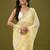 Yellow tissue satin embellished saree with unstitched blouse piece.