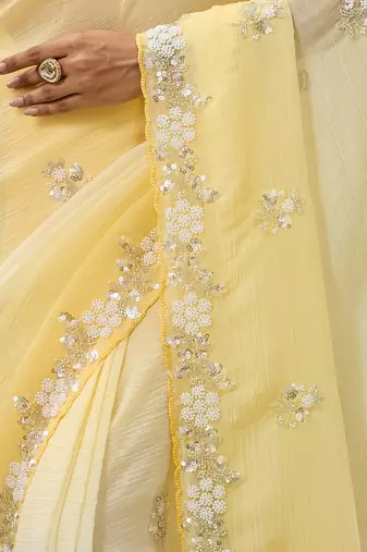 Yellow tissue satin embellished saree with unstitched blouse piece.