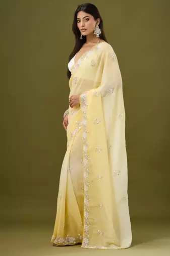 Yellow tissue satin embellished saree with unstitched blouse piece.