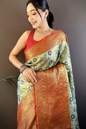 green silk blend saree with unstitched blouse piece.