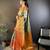 green silk blend saree with unstitched blouse piece.