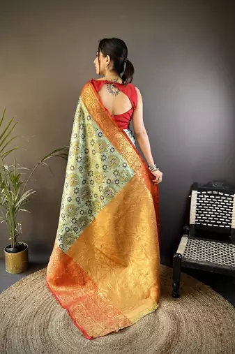 green silk blend saree with unstitched blouse piece.