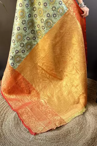 green silk blend saree with unstitched blouse piece.