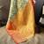 green silk blend saree with unstitched blouse piece.