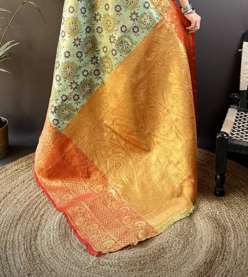 green silk blend saree with unstitched blouse piece.