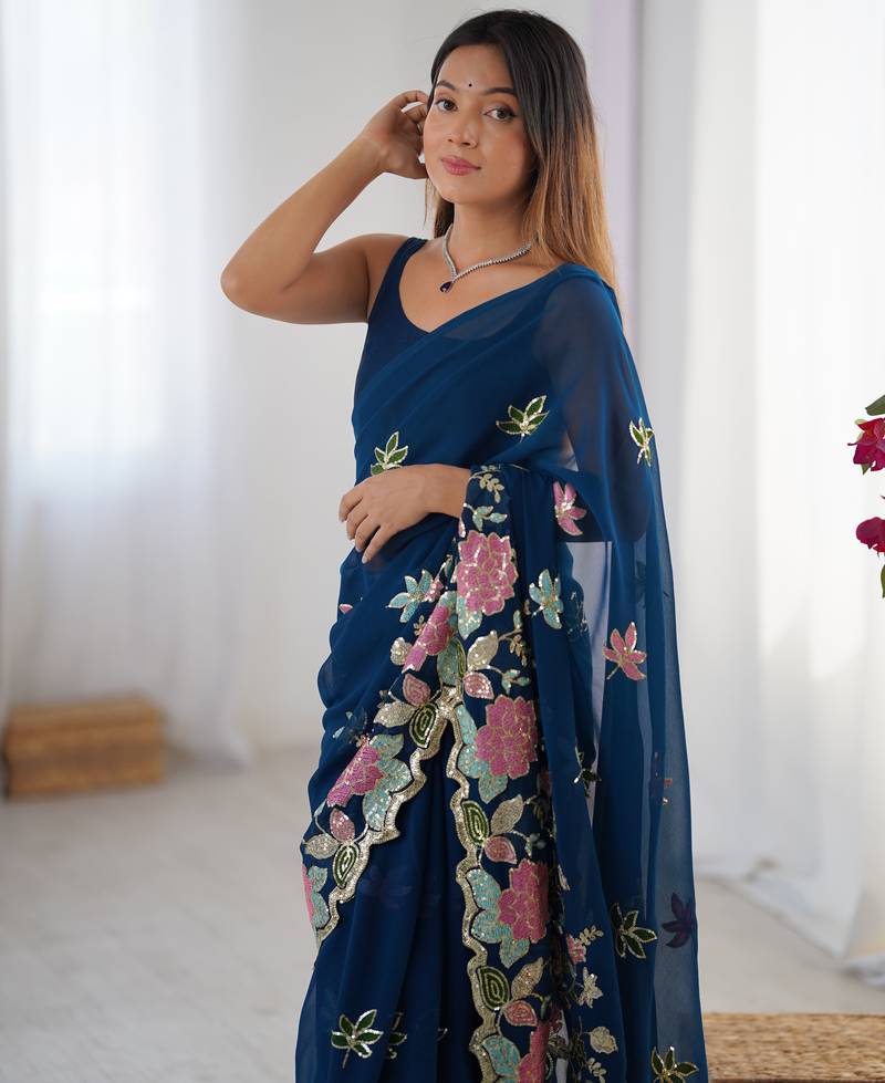 Teal georgette sequins saree with unstitched blouse piece.