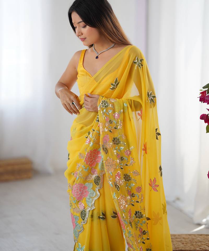 Yellow georgette sequins saree with unstitched blouse piece.