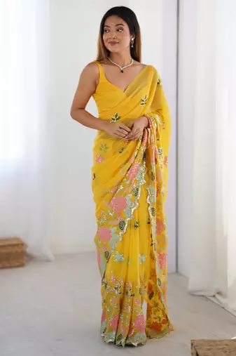 Yellow georgette sequins saree with unstitched blouse piece.