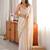 Cream tissue satin embroidered saree with unstitched blouse piece.