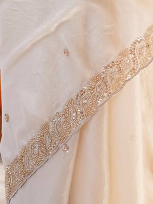 Cream tissue satin embroidered saree with unstitched blouse piece. 3