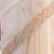 Cream tissue satin embroidered saree with unstitched blouse piece.