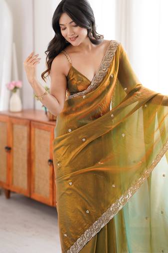Gold tissue satin embroidered saree with unstitched blouse piece.