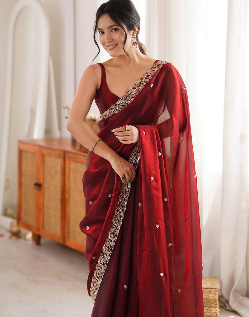Maroon tissue satin embroidered saree with unstitched blouse piece.