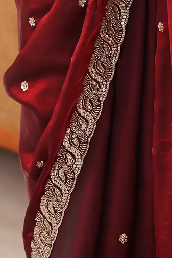 Maroon tissue satin embroidered saree with unstitched blouse piece.