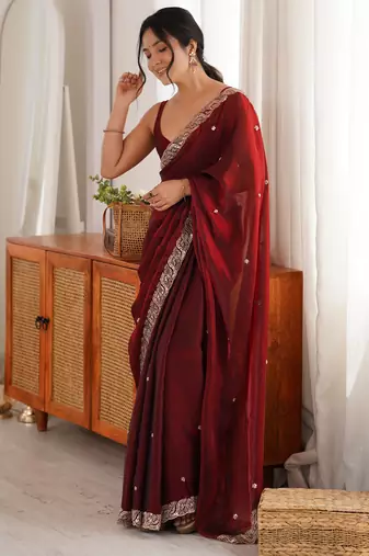 Maroon tissue satin embroidered saree with unstitched blouse piece.