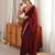 Maroon tissue satin embroidered saree with unstitched blouse piece.