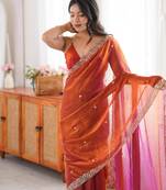 Orange tissue satin embroidered saree with unstitched blouse piece.
