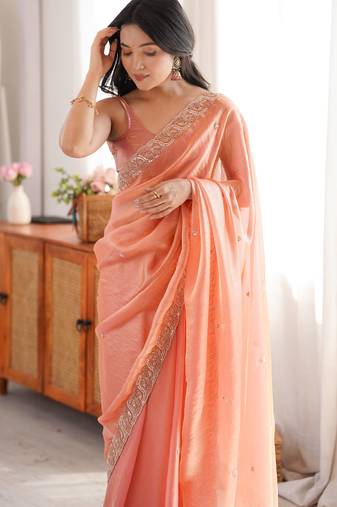 Peach tissue satin embroidered saree with unstitched blouse piece.