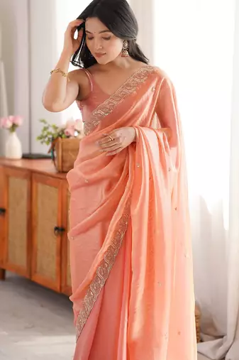 Peach tissue satin embroidered saree with unstitched blouse piece.