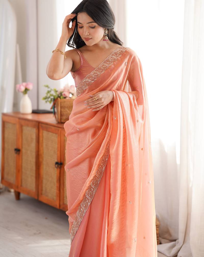 Peach tissue satin embroidered saree with unstitched blouse piece.