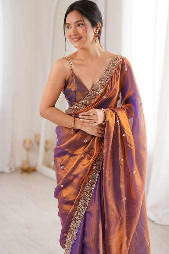 Rust tissue satin embroidered saree with unstitched blouse piece.