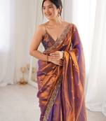Rust tissue satin embroidered saree with unstitched blouse piece.