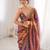 Rust tissue satin embroidered saree with unstitched blouse piece.