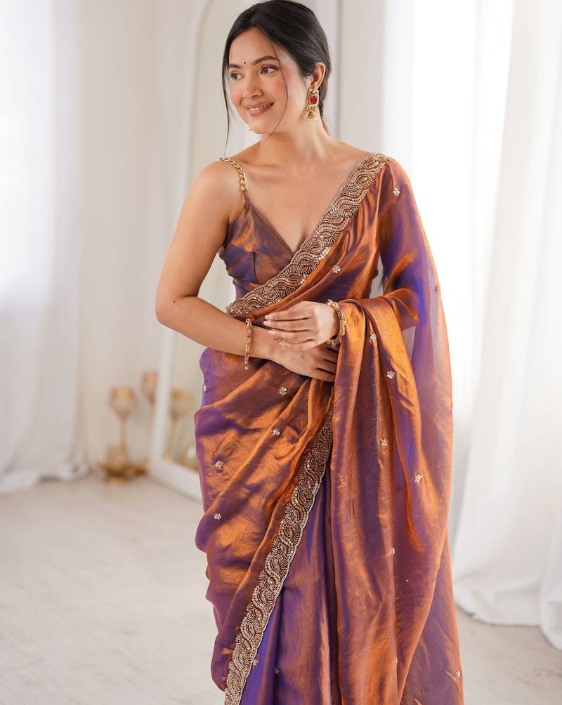 Rust tissue satin embroidered saree with unstitched blouse piece.
