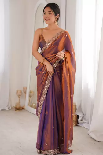 Rust tissue satin embroidered saree with unstitched blouse piece.