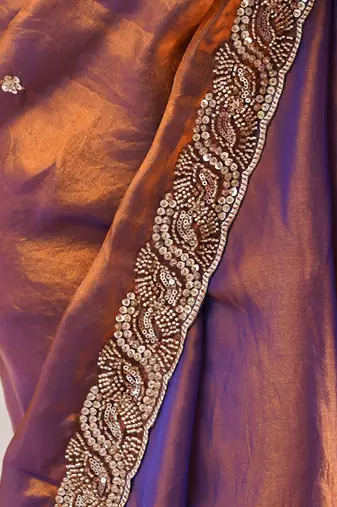 Rust tissue satin embroidered saree with unstitched blouse piece.
